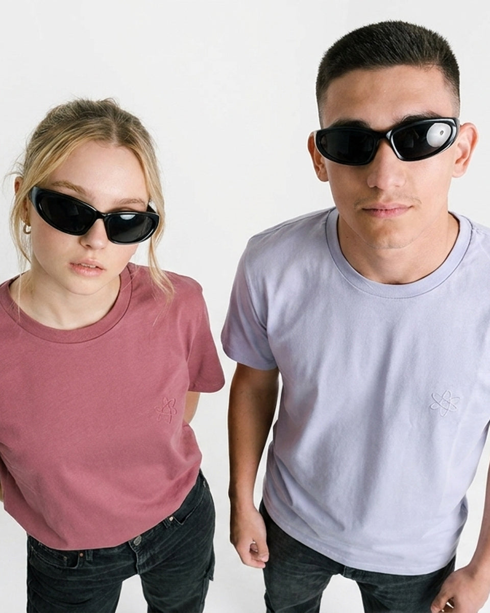 Two models wearing black sunglasses and t-shirts, standing against a plain white background.