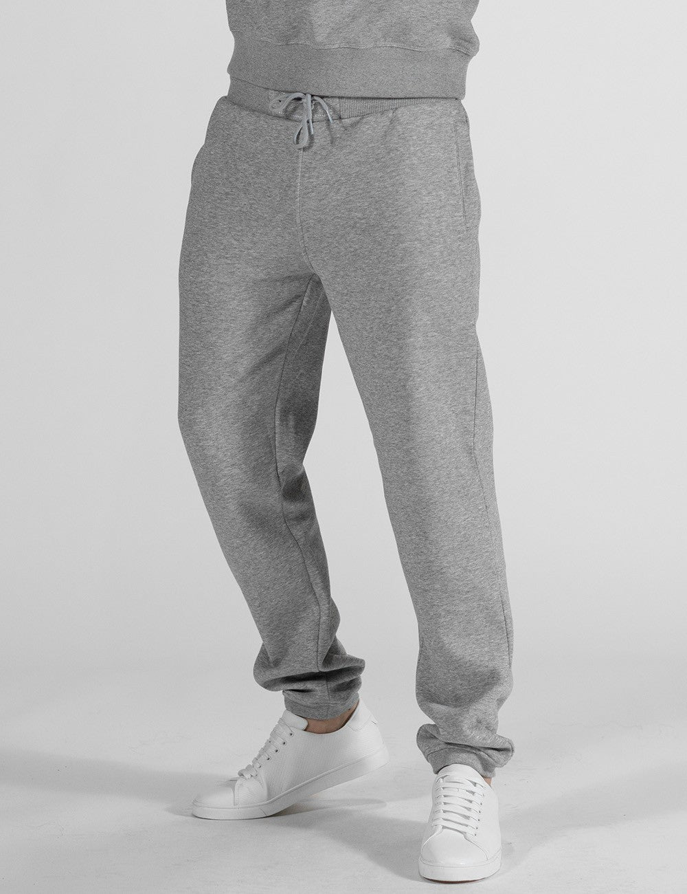 The image displays gray, Rocket Science heavy fleece sweatpants featuring an elastic waistband with a drawstring and cuffed ankles.