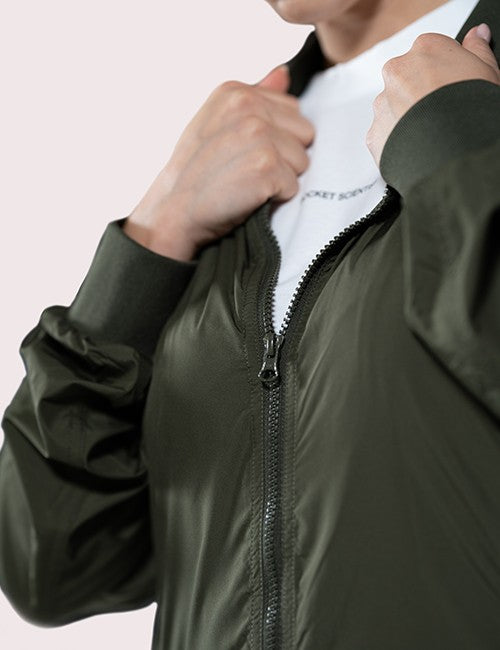 Close-up of a person wearing an olive green zip-front jacket .