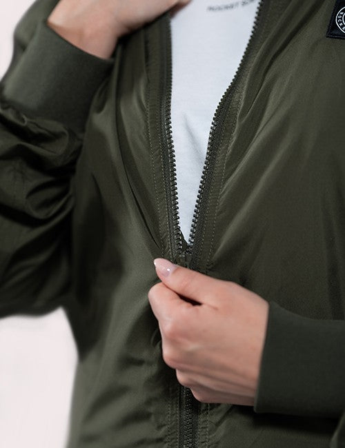 Close-up of a person wearing an olive green zip-front jacket .