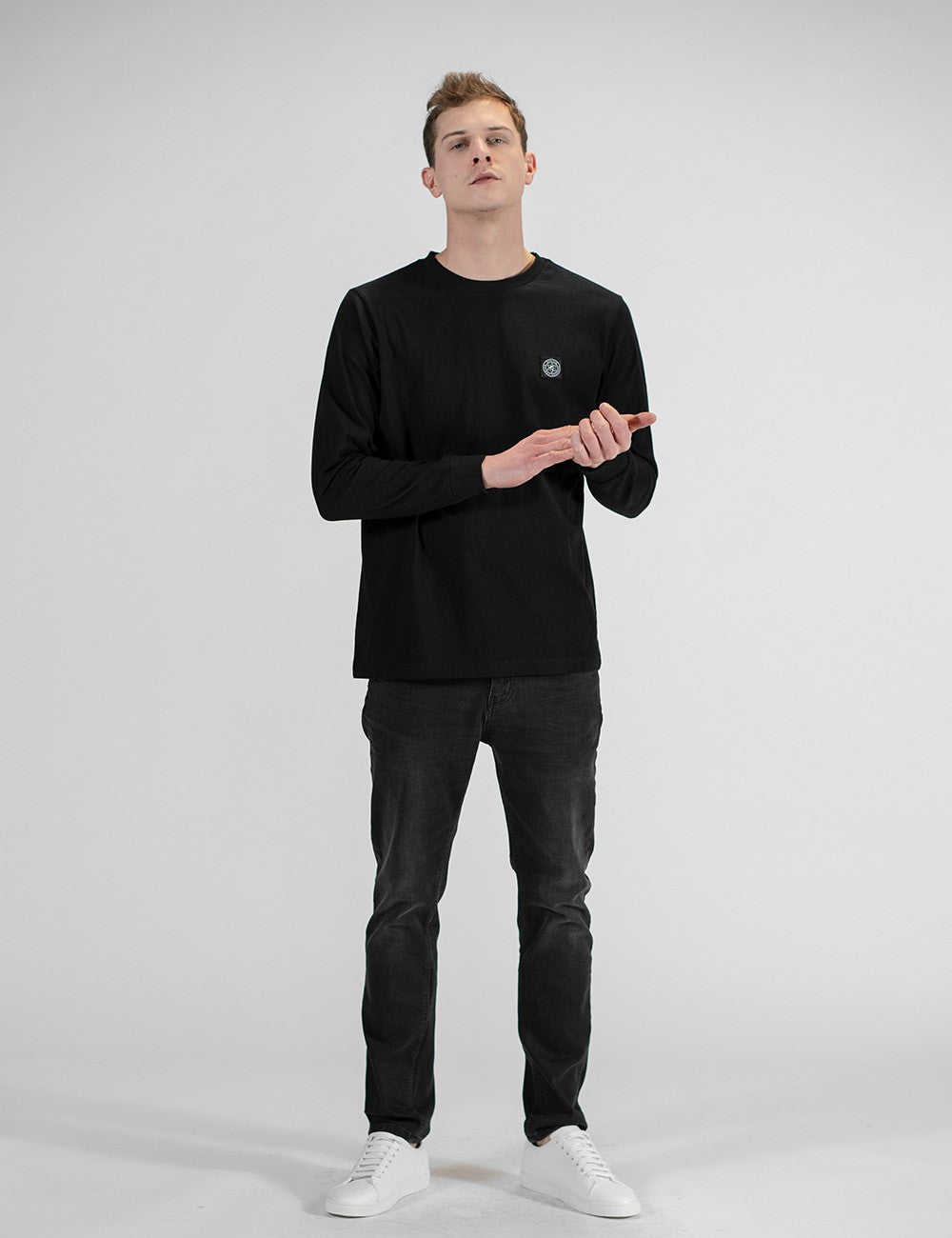 The model is wearing a Rocket Science Long Sleeve Shirt featuring the brand's signature logo patch on the chest.