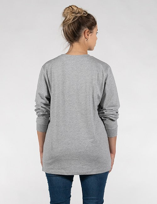 A woman viewed from the back wearing a loose-fitting, heather grey long-sleeve crewneck shirt and dark blue jeans. 