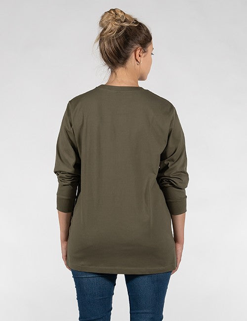 A woman stands with her back to the camera, showcasing a plain olive green or khaki long-sleeved shirt with ribbed cuffs. Her blonde hair is styled in a high bun. She is also wearing blue jeans against a plain, light grey background.