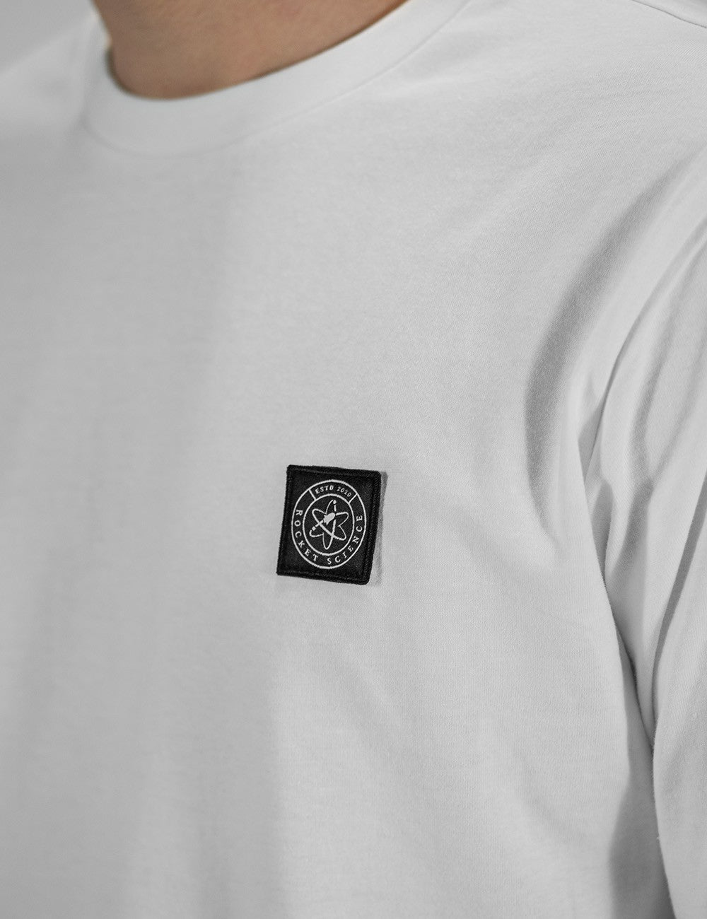 A close shot of the white Rocket Science longsleeve shirt logo.