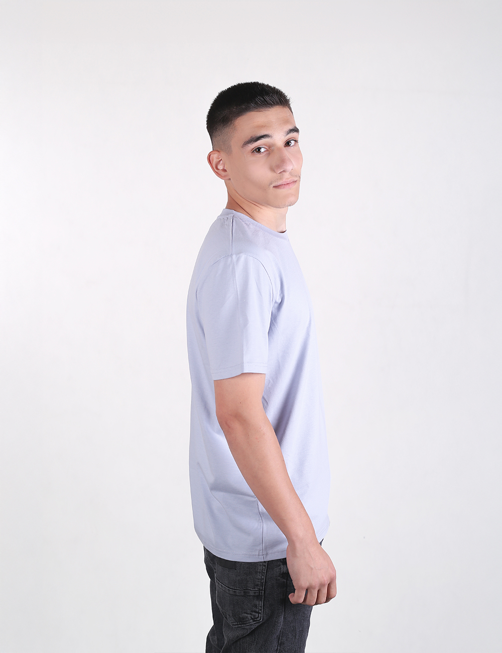 The person is wearing a simple light blue crew-neck t-shirt with a relaxed short-sleeve cut. 