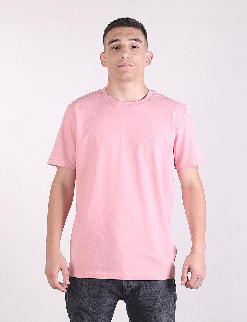 Person wearing a pink t-shirt against a white background