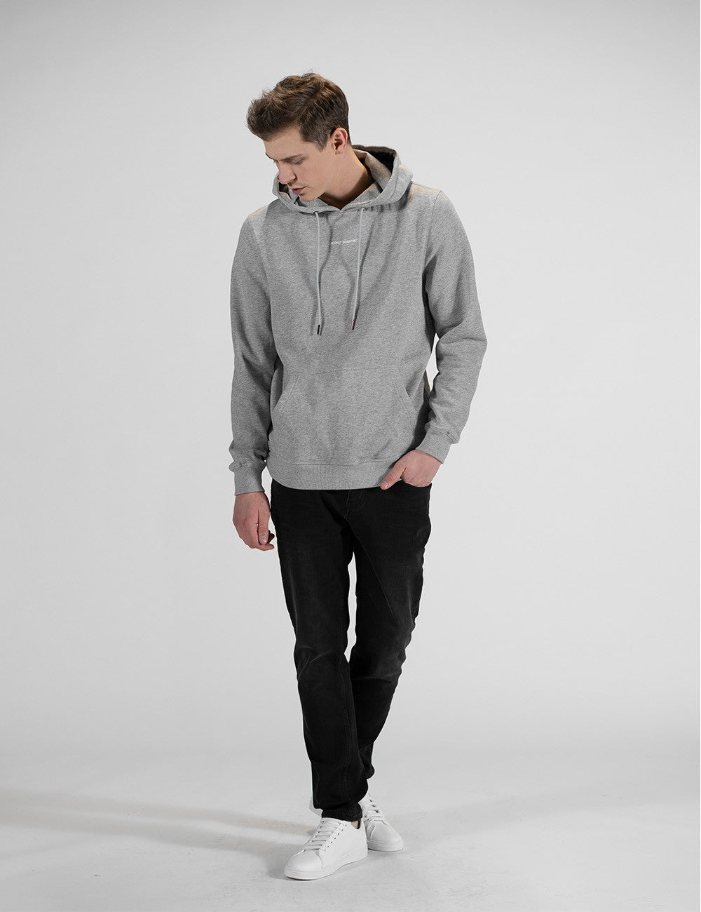 The person in the image is wearing a classic grey hooded sweatshirt  with a kangaroo pocket and matching drawstrings, and a Rocket Scientist print in the chest.