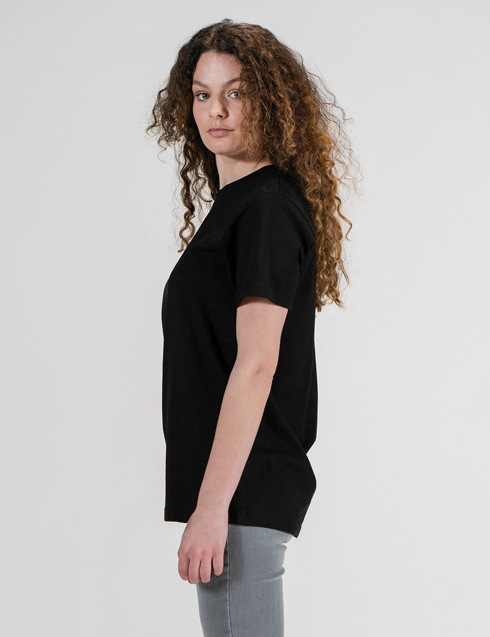 Woman showcasing a black round-neck T-shirt.