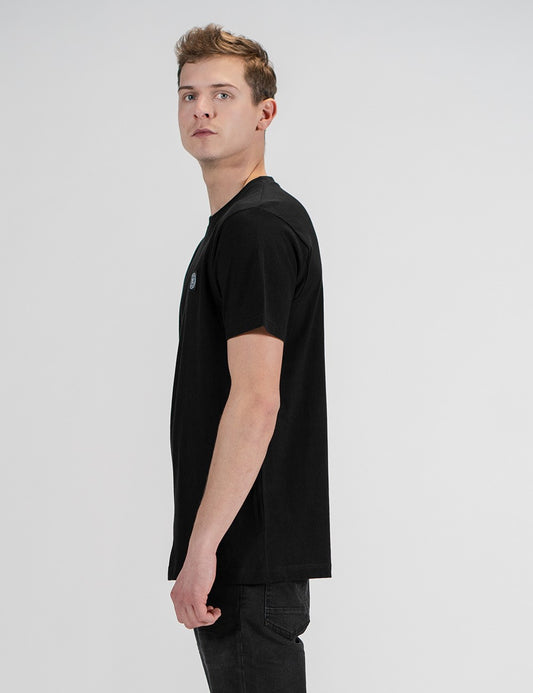 This image shows a side pose of young man wearing a black cotton crew-neck t-shirt 