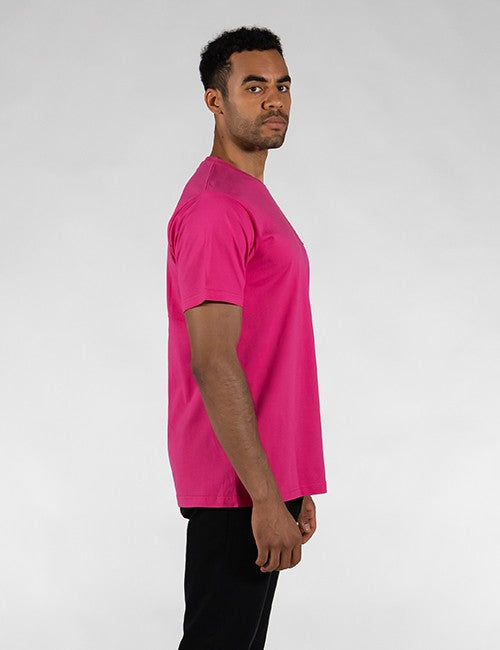 A man wearing a bright pink short-sleeve crewneck t-shirt, shown in profile against a light gray studio background.