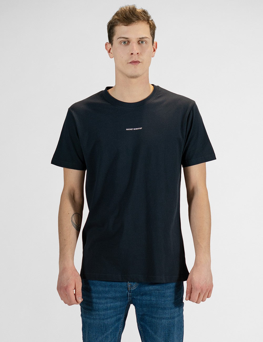 Navy blue crew neck t-shirt worn by male model with the words 'Rocket Scientist' on the front. 